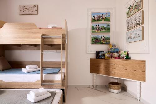 a bedroom with a bunk bed and a desk at Luxury White House - Villa & Weddings - Family Villa Near the Sea to the Famous Zorbas Beach in Stavros