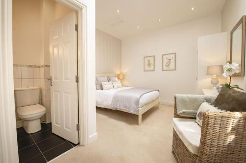 a bedroom with a bed and a toilet and a couch at Hill Top Farm 22 in Bainbridge