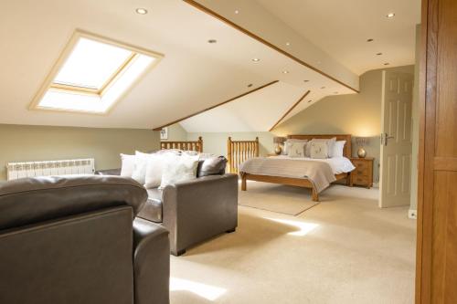 a attic bedroom with a bed and a skylight at Hill Top Farm 22 in Bainbridge