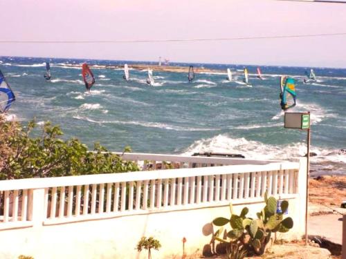 a group of people windsurfing in the ocean at ANEMOS SURF VIEw in Artemida