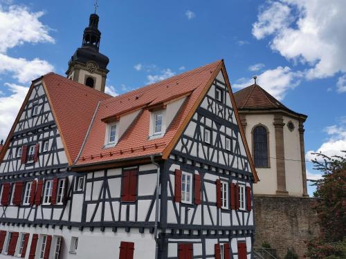 a black and white building with a clock tower at Im Herzen des Kraichgaus 2 in Östringen