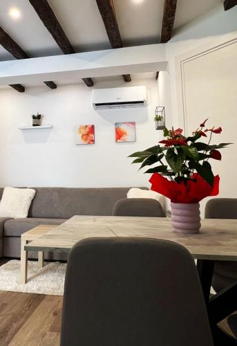 a living room with a table and a couch at Casa Salvia in Koper