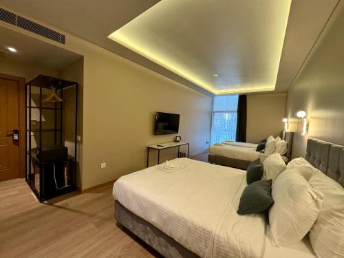a hotel room with two beds and a television at W Suites Istanbul in Istanbul