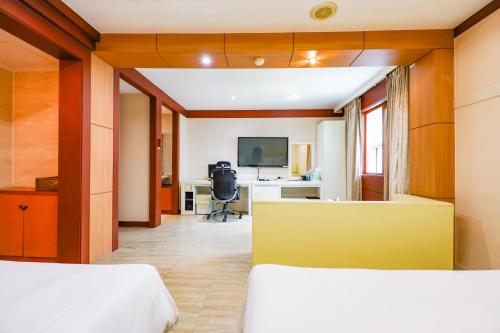 a bedroom with two beds and a desk at Hotel Charlot Castle in Pyeongtaek