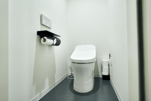 a bathroom with a white toilet in a room at Rakuten STAY Osaka Station North in Osaka