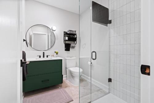 a bathroom with a sink and a mirror and a toilet at Capital Apartments in Ottawa