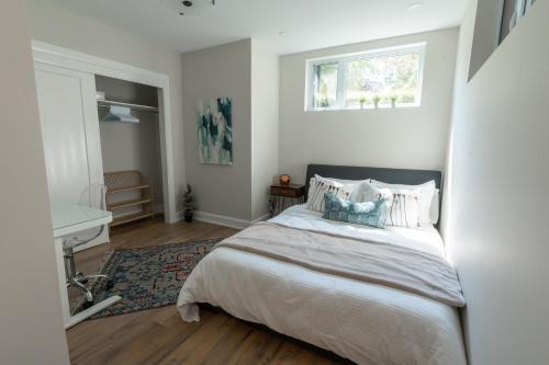 a bedroom with a large bed and a window at Capital Apartments in Ottawa