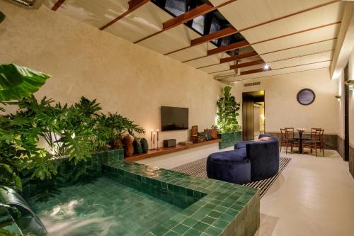 a living room with a swimming pool with plants at Officina Daplace in Rome