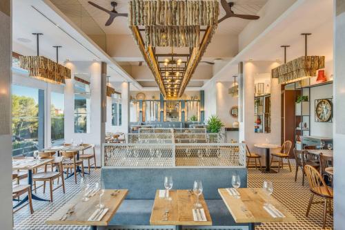 a restaurant with tables and chairs and a fountain at Pestana Blue Alvor Beach - All Inclusive Hotel in Alvor