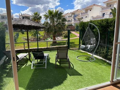 a yard with two chairs and a swing at Casa Leonardo Luxury Esury in Ayamonte