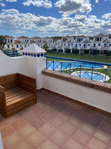 a balcony with a bench next to a swimming pool at Casa Leonardo Luxury Esury in Ayamonte