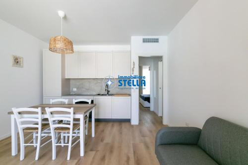a kitchen and living room with a table and chairs at Wave Island in Lido di Jesolo