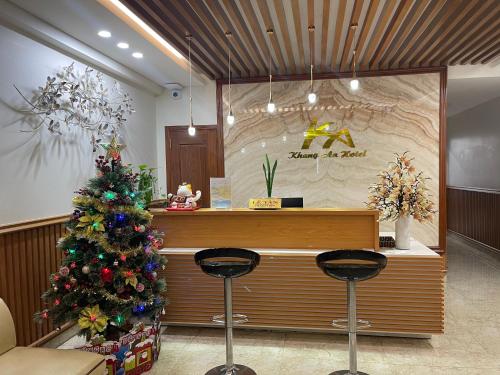 a christmas tree in front of a counter in a store at Khách sạn Khang An Buôn Ma Thuột in Buon Ma Thuot