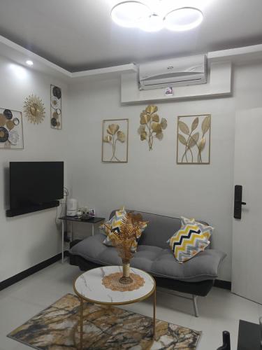 a living room with a couch and a table at TMD COMFORTABLE TRANSIENT HOUSE IN STO.TOMAS BATANGAS (UNIT 1) in San Felix