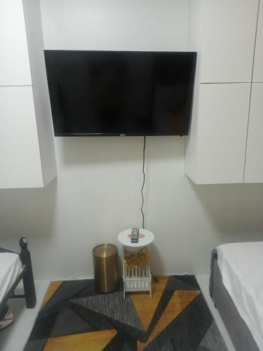 a flat screen tv hanging on a white wall at TMD COMFORTABLE TRANSIENT HOUSE IN STO.TOMAS BATANGAS (UNIT 1) in San Felix