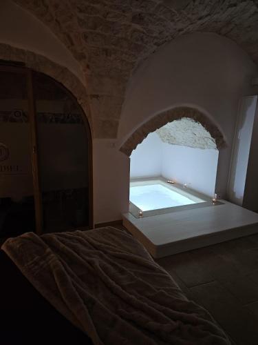 a bedroom with a large window with a swimming pool at Muribel Maison in Ceglie Messapica