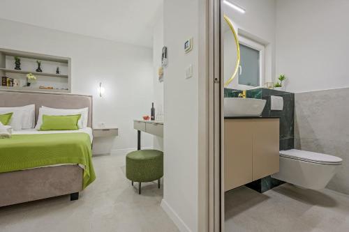 a bedroom with a bed and a sink and a mirror at Antique Spalato Luxury Rooms in Split
