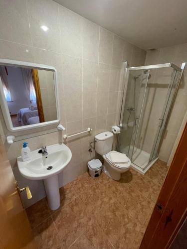 a bathroom with a toilet and a sink and a shower at Hostal La Rurala Estopanyà in Estopiñán