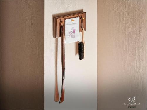 a refrigerator with a brush on the side of it at Daiwa Roynet Hotel Chiba Ekimae in Chiba