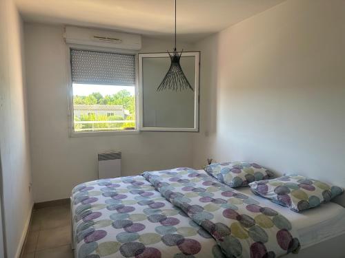 Schlafzimmer mit einem Bett und einem Fenster in der Unterkunft Appartement Allauch in Allauch