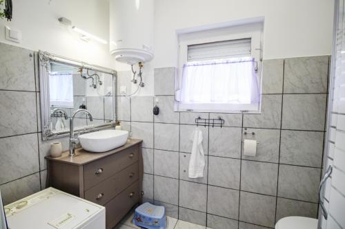 a bathroom with a sink and a mirror at Levendula Apartman Berekfürdő in Berekfürdő