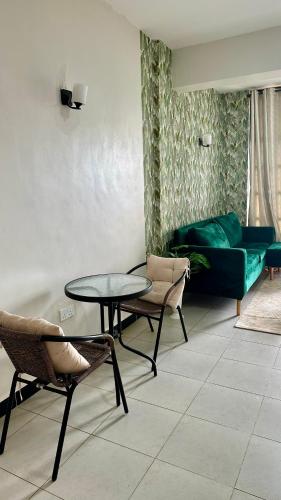 a living room with a couch and a table and chairs at Rorot 1 bedroom annex Eldoret,Arlene in Eldoret