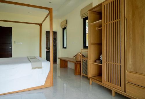 a bedroom with a bed and a large mirror at The Cove in Panwa Beach
