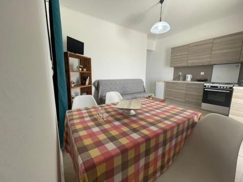 a room with a table and chairs and a kitchen at Majestic Sunset in Mastichari