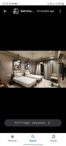 a picture of a bedroom with two beds and a television at hotel sonali regency in Bhopal