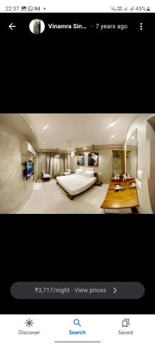 a picture of a room with a bed and a living room at hotel sonali regency in Bhopal