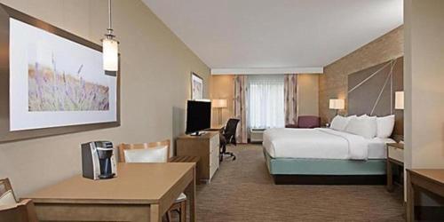 a hotel room with a bed and a desk at Holiday Inn Express & Suites New Cumberland by IHG in New Cumberland