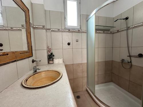 a bathroom with a sink and a shower at White Houses Villas in Gennadi