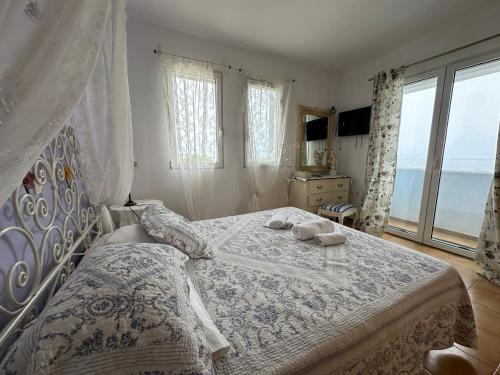 a bedroom with a bed with two towels on it at White Houses Villas in Gennadi