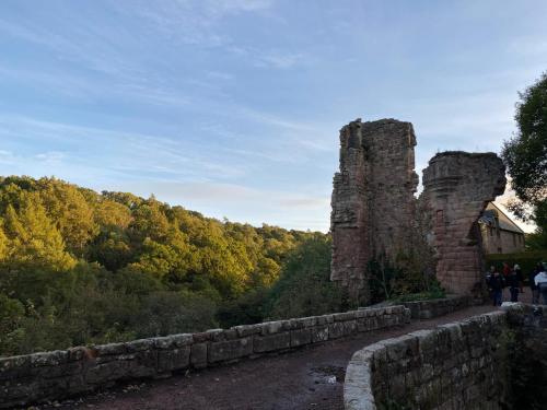 a stone wall with two ruins of a castle at Lovely Countryside Getaway in Roslin