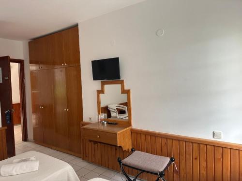 a room with a bed and a tv on the wall at NATURELLA APART HOTEL in Kemer