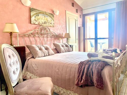 a bedroom with a large bed and a window at CasAzzurra in Ortona