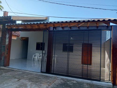 a garage door with blinds on a house at Casa Luna da Boa vista in Bonito