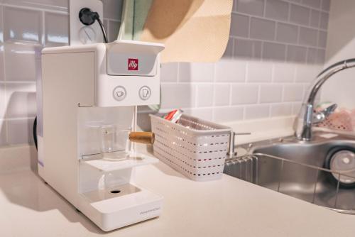 a kitchen counter with a coffee maker on a counter at Staylim - Seoul Botanic Park, Airport in Seoul