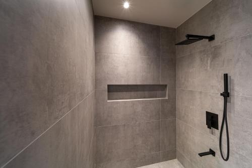 a bathroom with a shower with a shower head at Afesou Suites in Ialyssos