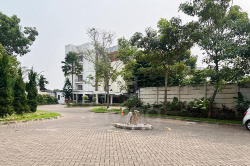a statue in the middle of a street in front of a building at RedLiving Apartemen Eco Home - Wieg's Room Tower B Yashinoki in Tangerang