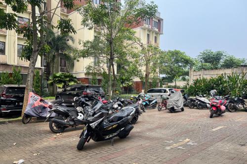 a group of motorcycles parked next to a building at RedLiving Apartemen Eco Home - Wieg's Room Tower B Yashinoki in Tangerang