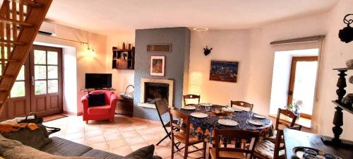 un salon avec une table et une cheminée dans l'établissement La maison d' Anne , nature et convivialité ..., à Albas