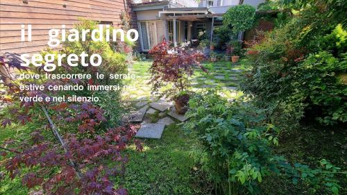 a garden with flowers and plants in front of a house at Albergo Trieste in Boves