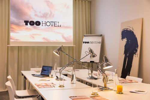 a conference room with a table with a laptop on it at Too Hotel & Spa Paris - MGallery Collection in Paris