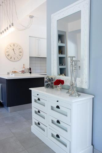 a white dresser in a kitchen with a mirror at Serenity Villa in Sani in Sani Beach
