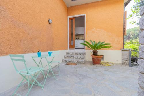 a patio with two chairs and a table at Casa Fetovaia - HelloElba in Fetovaia