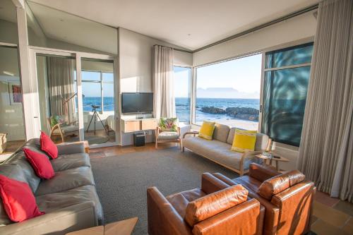 a living room with a view of the ocean at Bokkombaai in Bloubergstrand