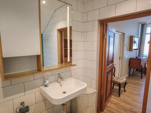 a bathroom with a sink and a mirror at Bokkombaai in Bloubergstrand