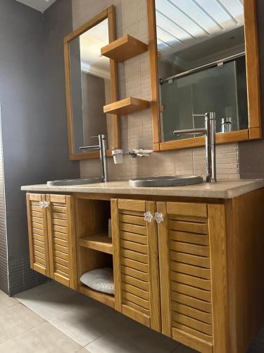 a bathroom with a sink and a mirror at Palm Djerba Suites in Mezraya