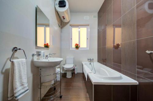 a bathroom with a sink and a tub and a toilet at Sliema 2 Bedroom close to seafront in Sliema